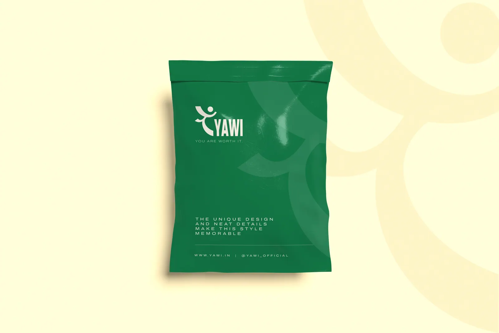A green YAWI courier bag carrying the logo, on a cream backdrop.