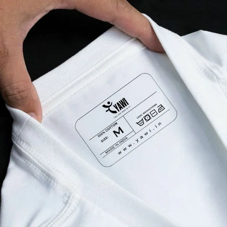 The printed YAWI neck label inside a white T-shirt, with the size, 100% cotton, made in India and www.yawi.in.
