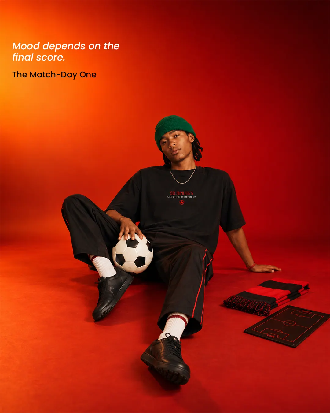 A YAWI social post on red: a model in a YAWI tee, sitting with a football.