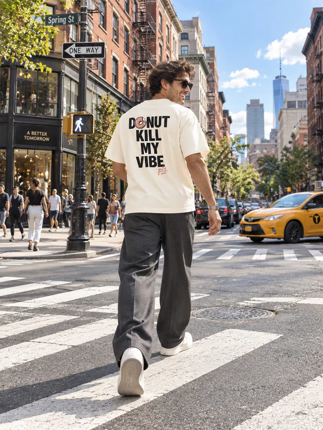 A street photo from a YAWI shoot: a model walking in a white YAWI tee.