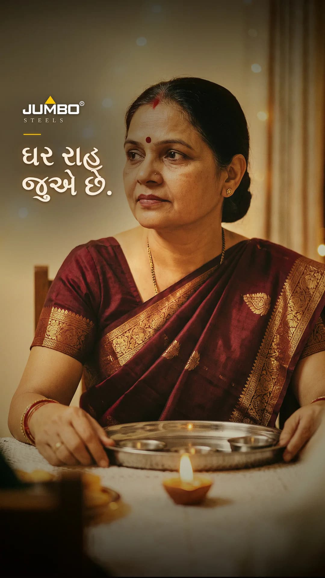 The cover of a JUMBO reel, Ghar raah jue che in Gujarati: a woman in a maroon sari holding a brass thali with a lit diya.