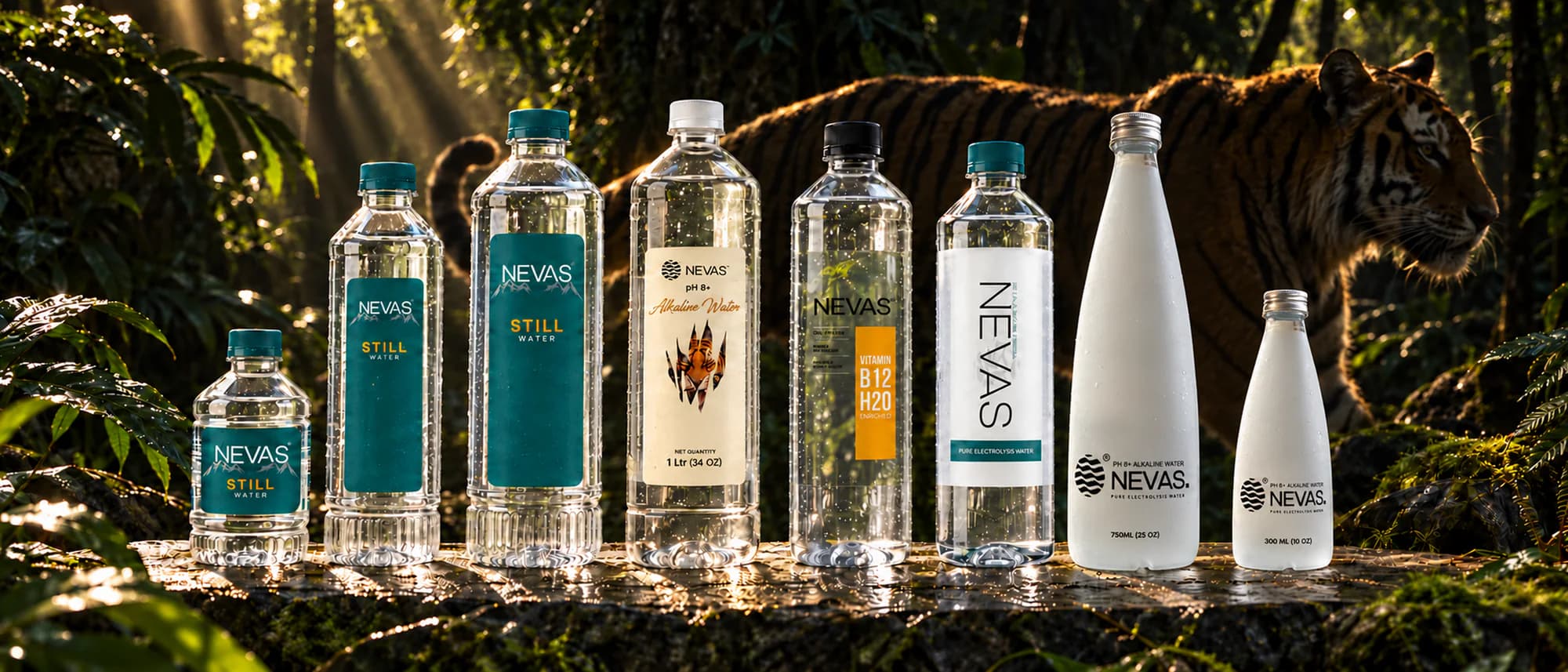 The NEVAS range on a sunlit jungle rock, a tiger walking behind: three sizes of still water, the tiger-label alkaline, Vitamin B12 H2O, the white-label alkaline and two frosted glass bottles.