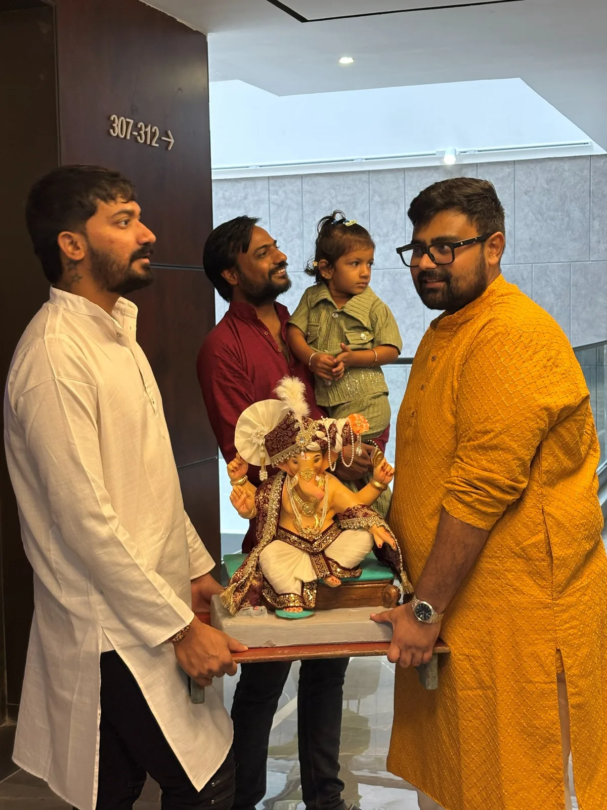 Teammates bringing Ganapati into the office