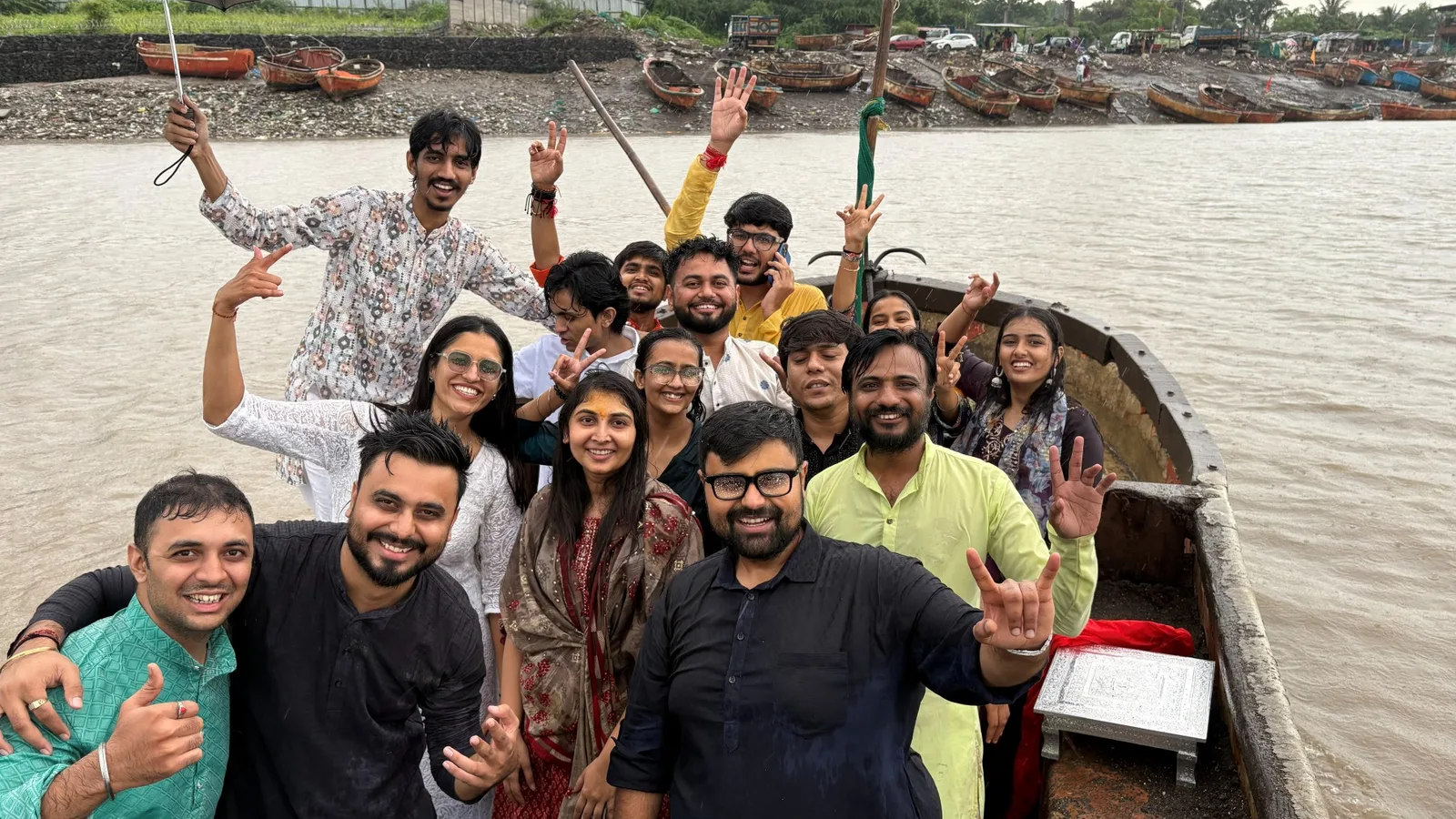 The team cheering on a boat at the Ganapati visarjan